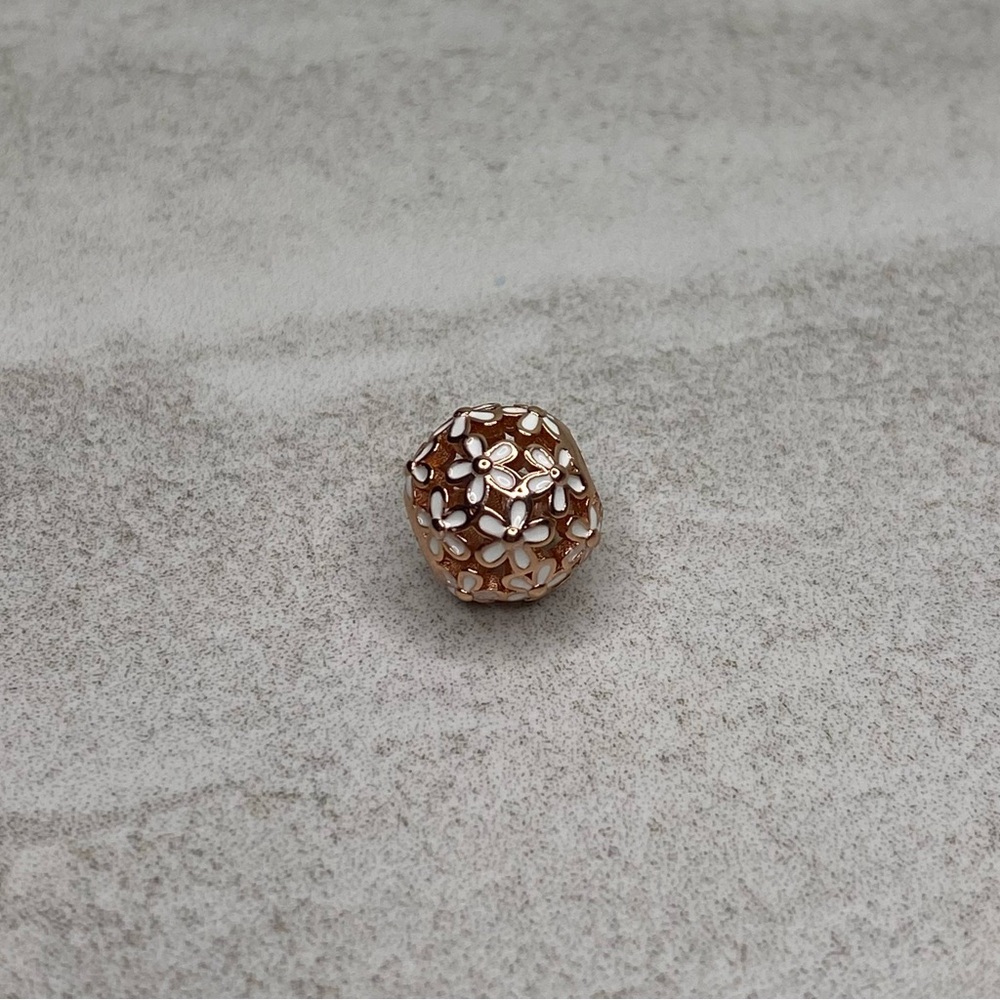 Rose gold and white flower charm.